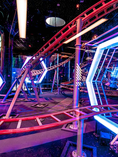 Roller coaster track with neon lights at Doha Quest Theme Park.