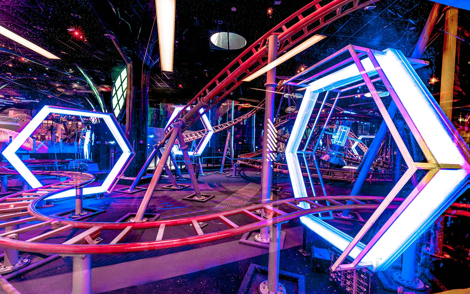 Roller coaster track with neon lights at Doha Quest Theme Park.