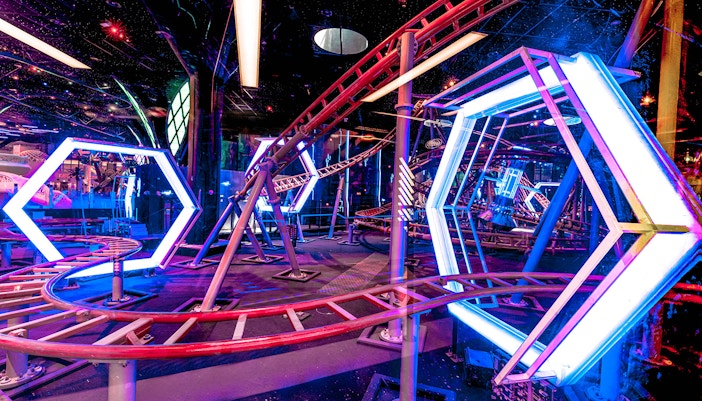 Roller coaster track with neon lights at Doha Quest Theme Park.