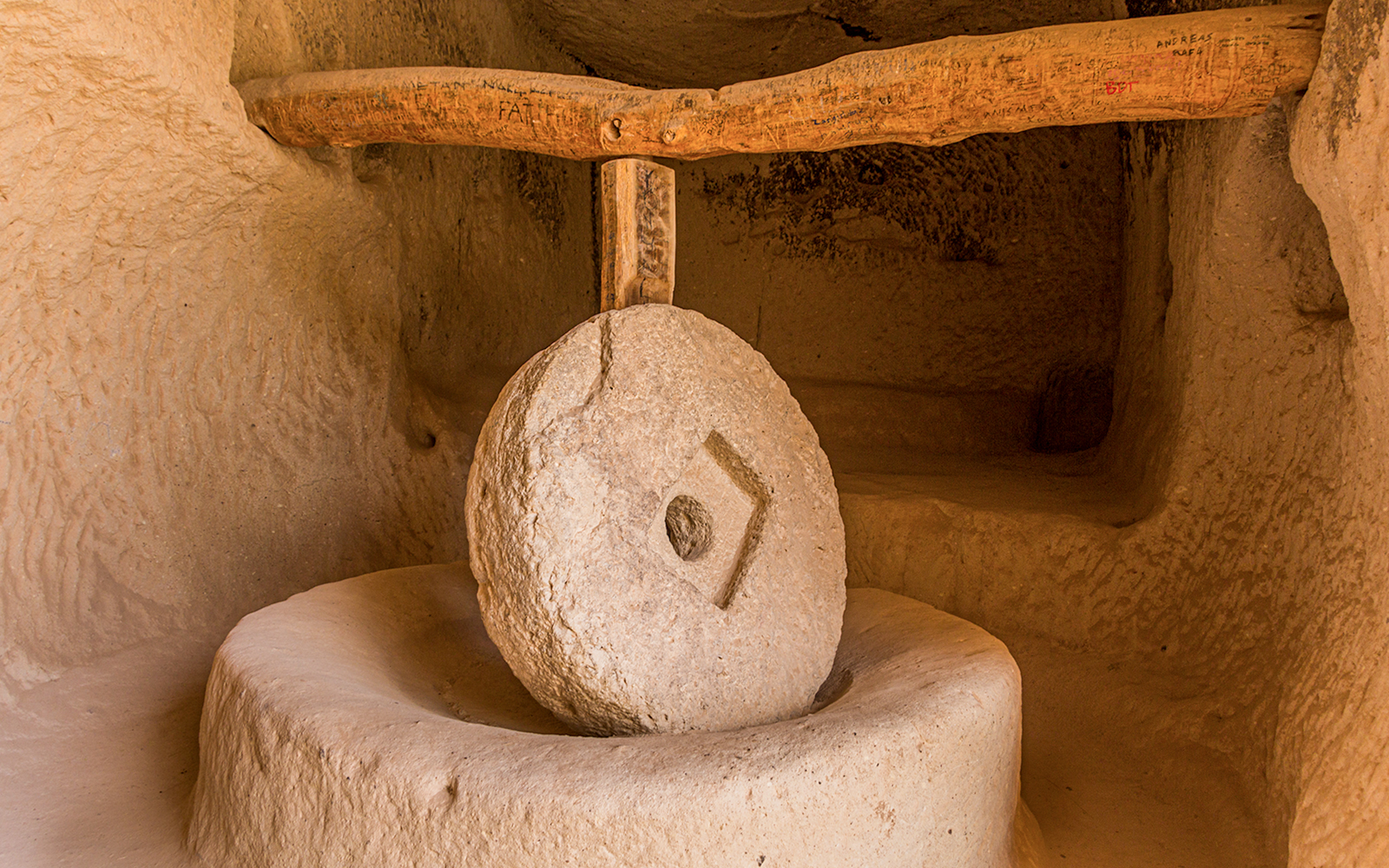 Old stone mill inside rock dwelling in Zelve, Cappadocia, Turkey.