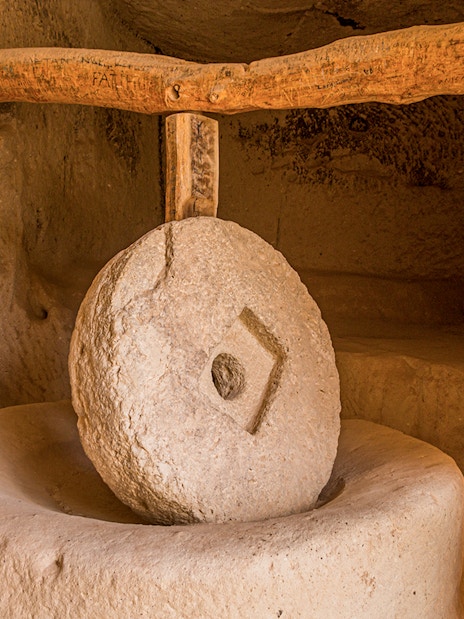 Old stone mill inside rock dwelling in Zelve, Cappadocia, Turkey.