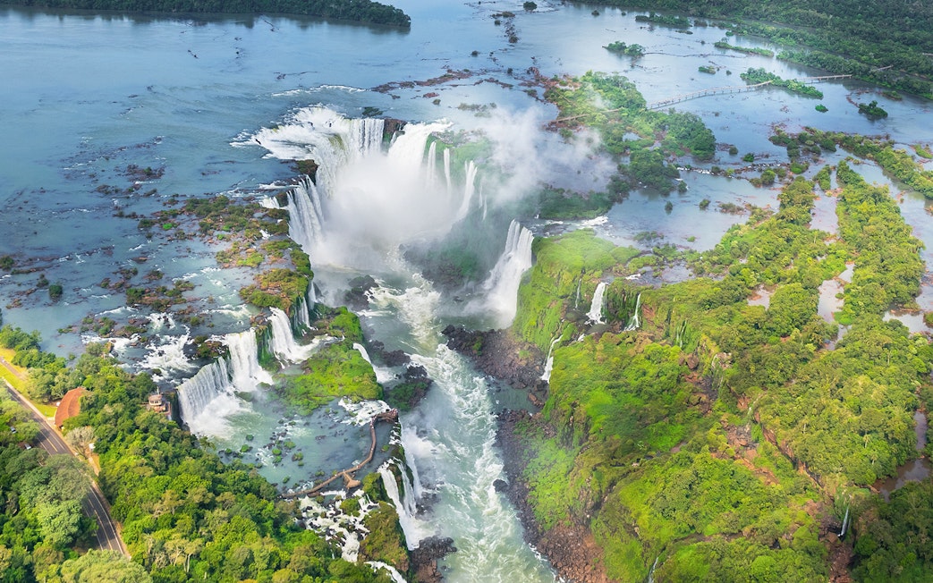 Aerial view of Iguazu Falls with cascading waterfalls and lush greenery in Argentina.