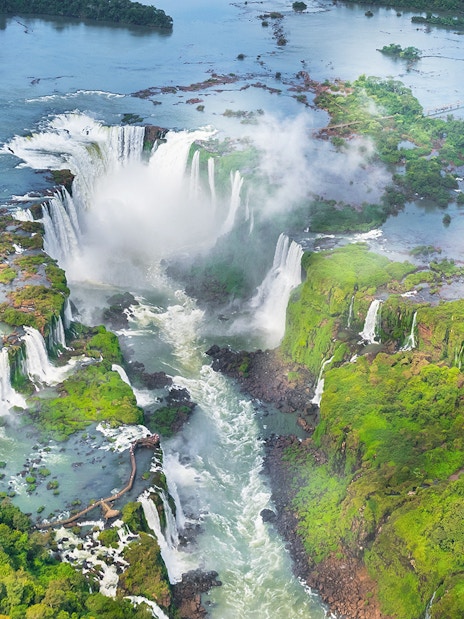 Aerial view of Iguazu Falls with cascading waterfalls and lush greenery in Argentina.