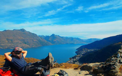Quad biker relaxing with view of Lake Wakatipu and mountains, Queenstown Quad Bike Tour.