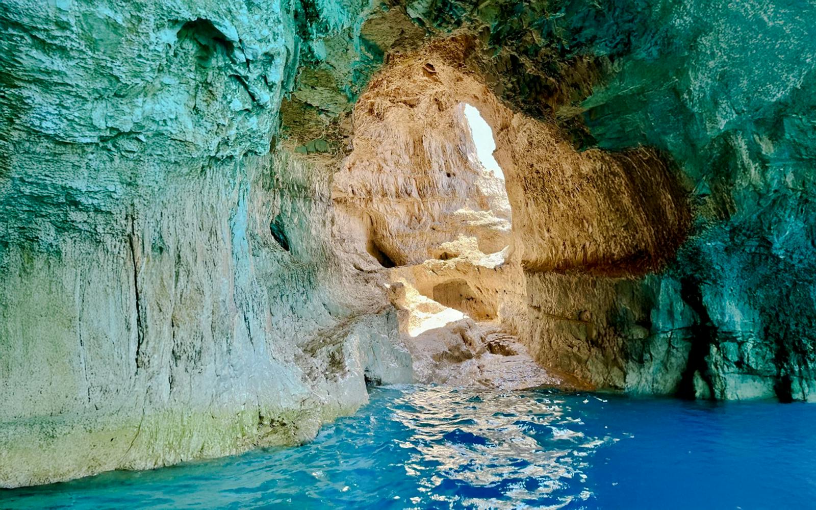 Blue caves interior with sunlight reflecting on water, Zakynthos, Greece.