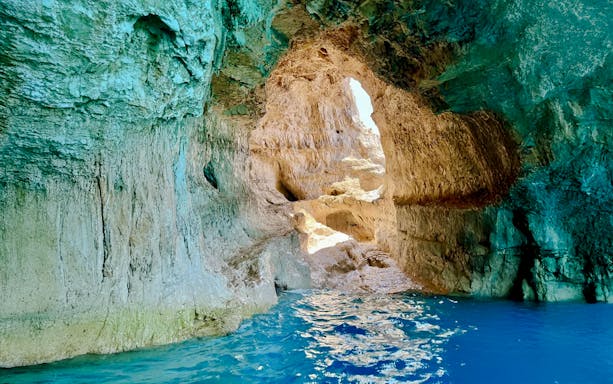 Blue caves interior with sunlight reflecting on water, Zakynthos, Greece.