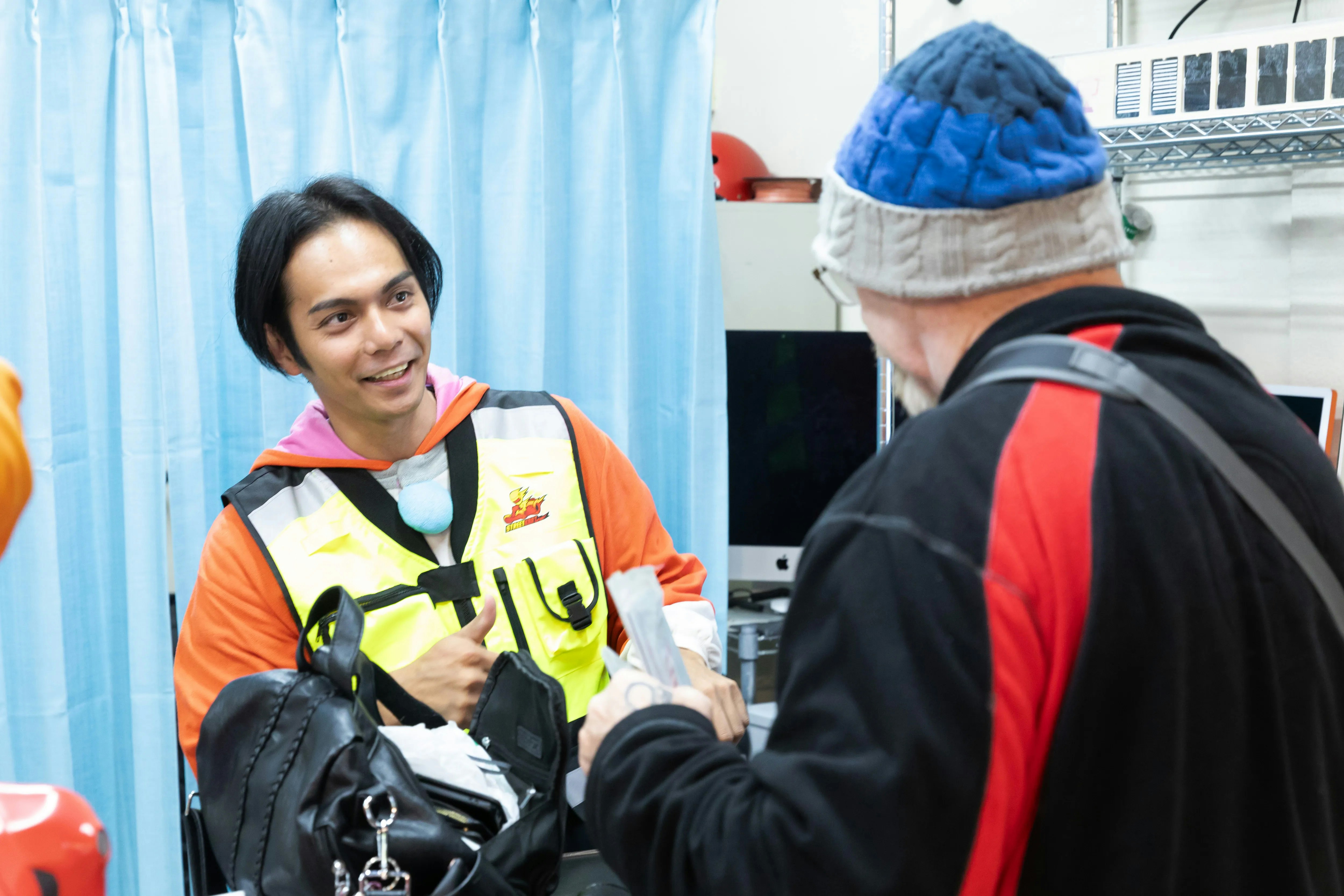 Staff member assists guest at Shibuya Go Karting, Tokyo.