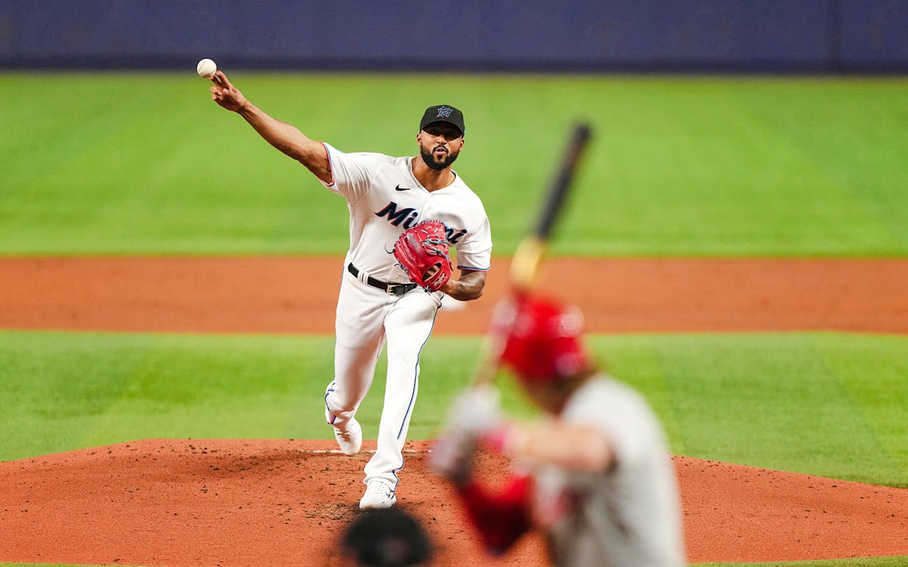 Pitcher throwing a baseball during a Miami Marlins game.