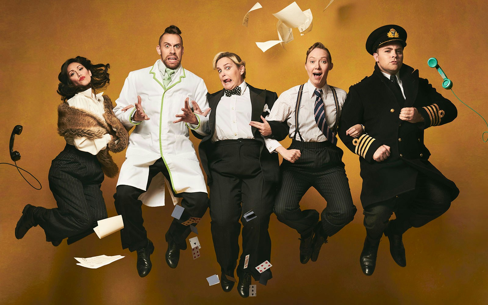 Performers in vintage attire jumping mid-air for "Operation Mincemeat: A New Musical.