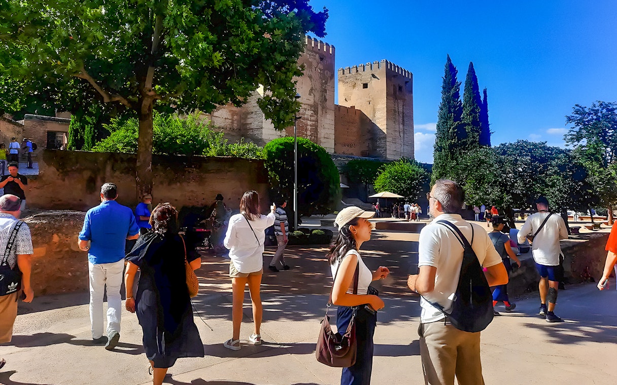 Tourists exploring the grounds near the Alhambra in Granada, Spain.