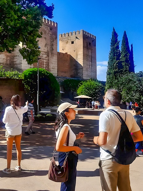 Tourists exploring the grounds near the Alhambra in Granada, Spain.