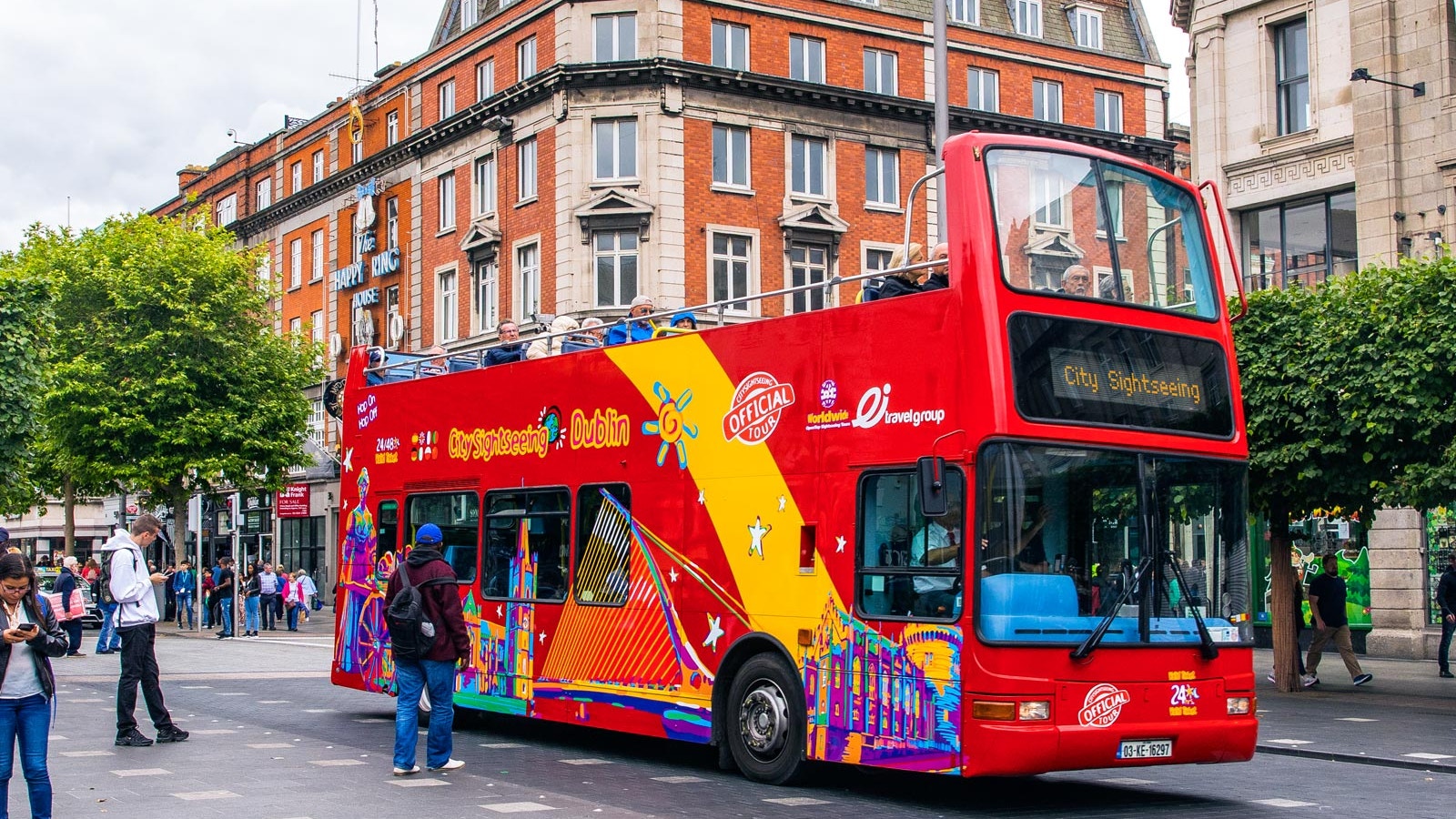 Hop-on hop-off bus in Dublin with view of Guinness Storehouse and Gravity Bar.