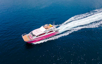 Speed catamaran cruising on blue waters, Phuket Racha and Coral Islands day trip.