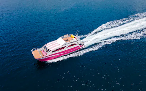 Speed catamaran cruising on blue waters, Phuket Racha and Coral Islands day trip.