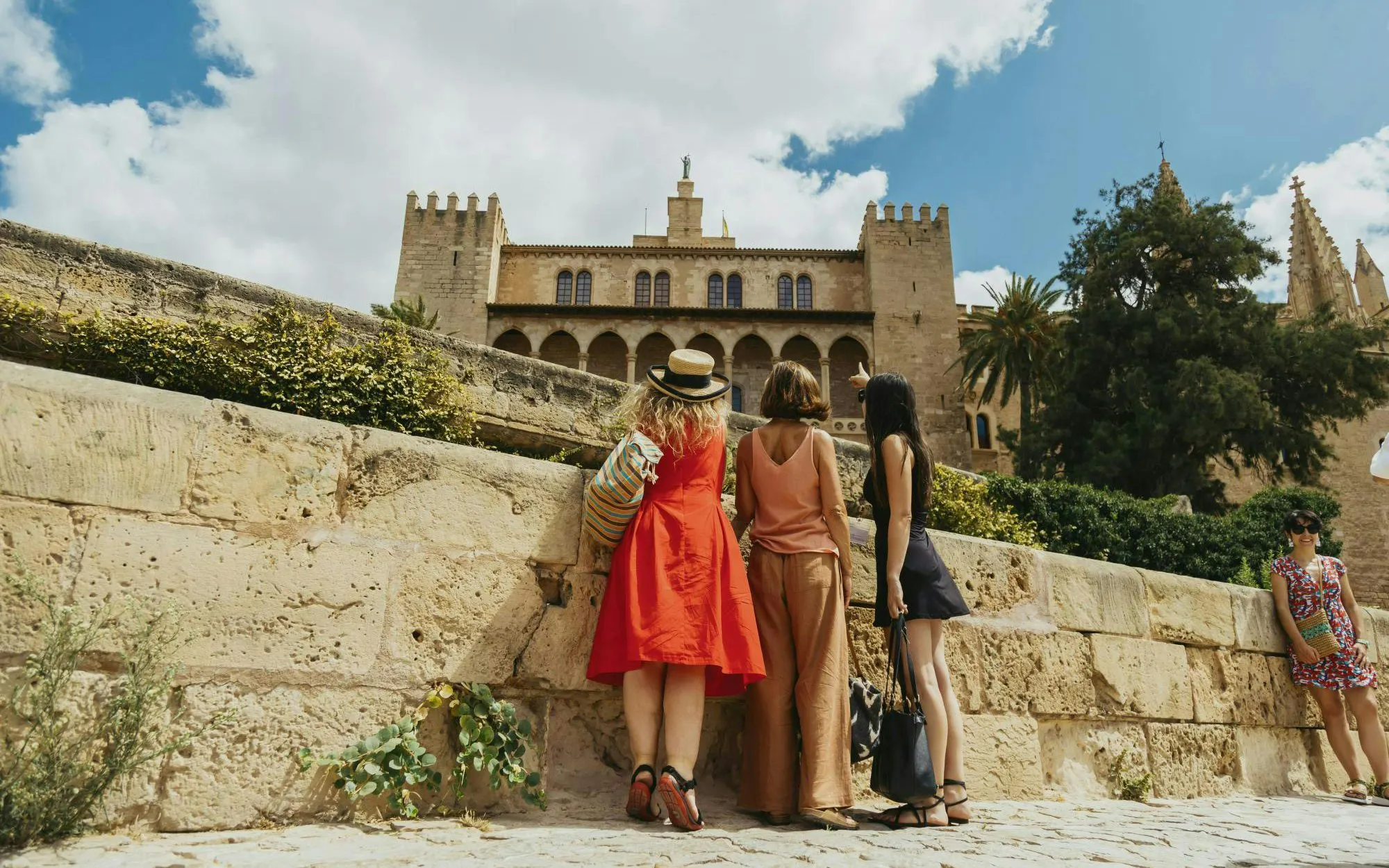 Tourists in front of Royal Palace of La Almudaina, Palma de Mallorca, Spain.