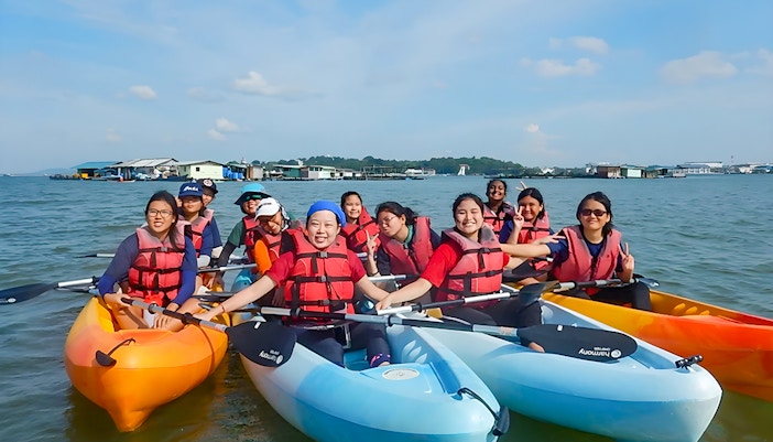 Kayakers in life vests paddling near floating houses at Pulau Ubin, Singapore.