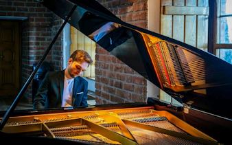 Pianist performing at Chopin Concert, Royal Castle Complex, Warsaw.
