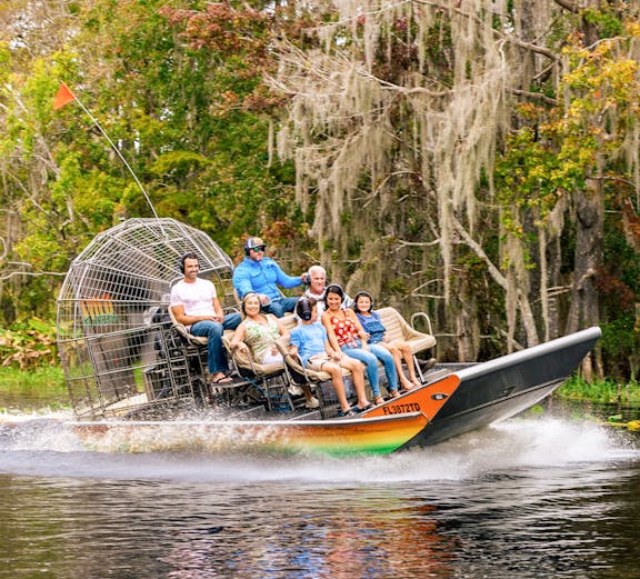 Tourists exploring a historic street with colorful buildings in a European city.