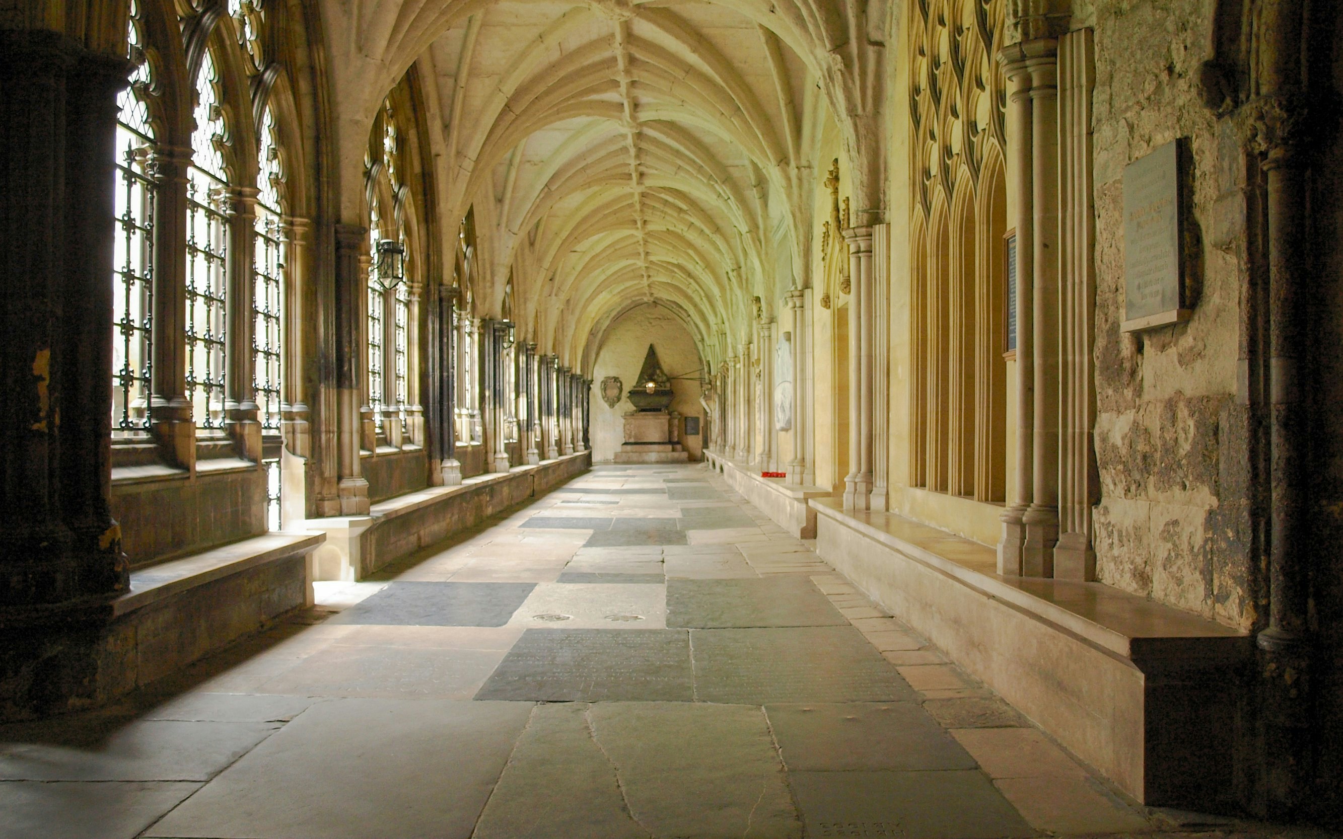 Westminster Abbey cloisters with vaulted ceilings and arched windows in London.