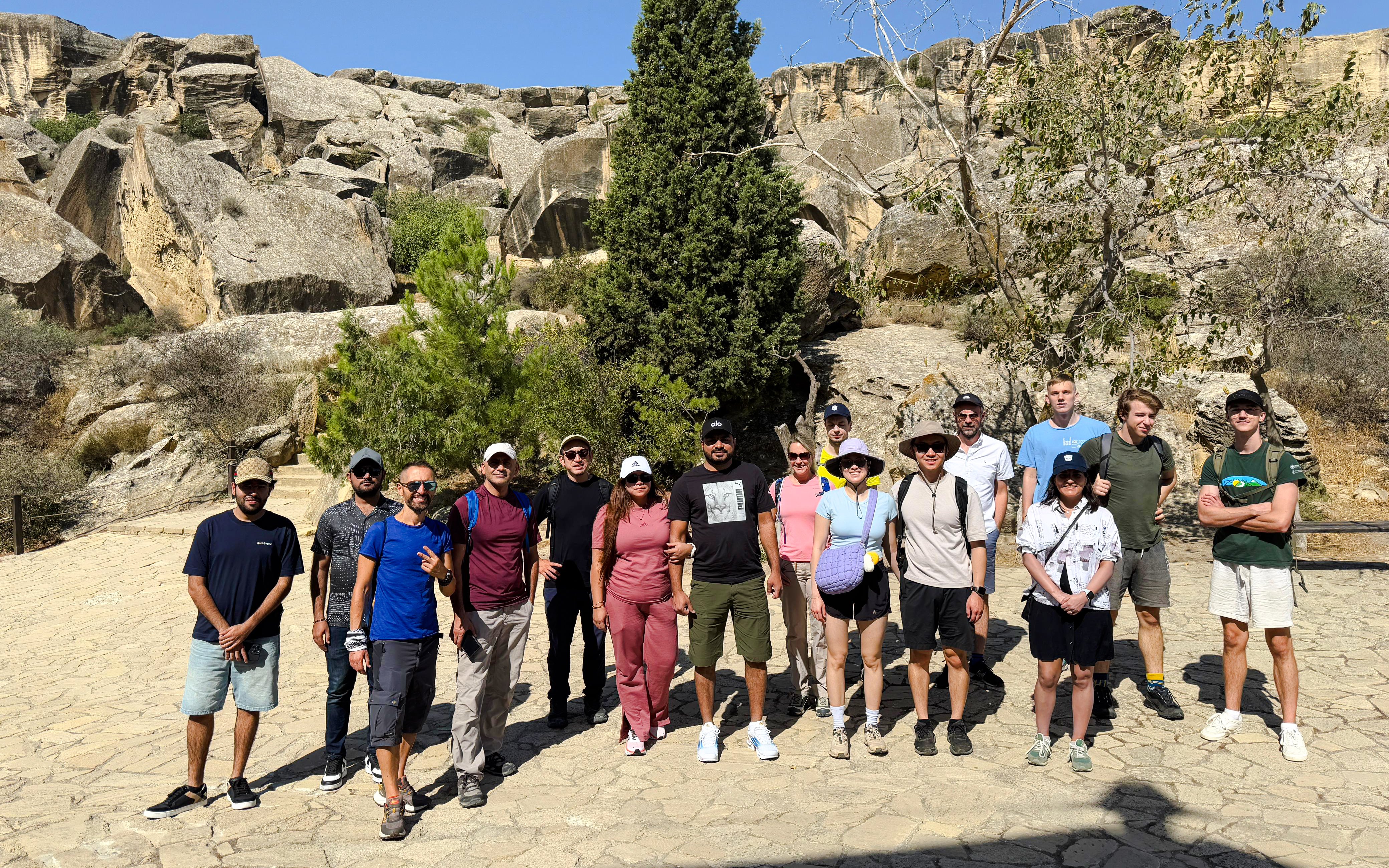 Group of tourists at Gobustan National Park with rocky landscape in Azerbaijan.