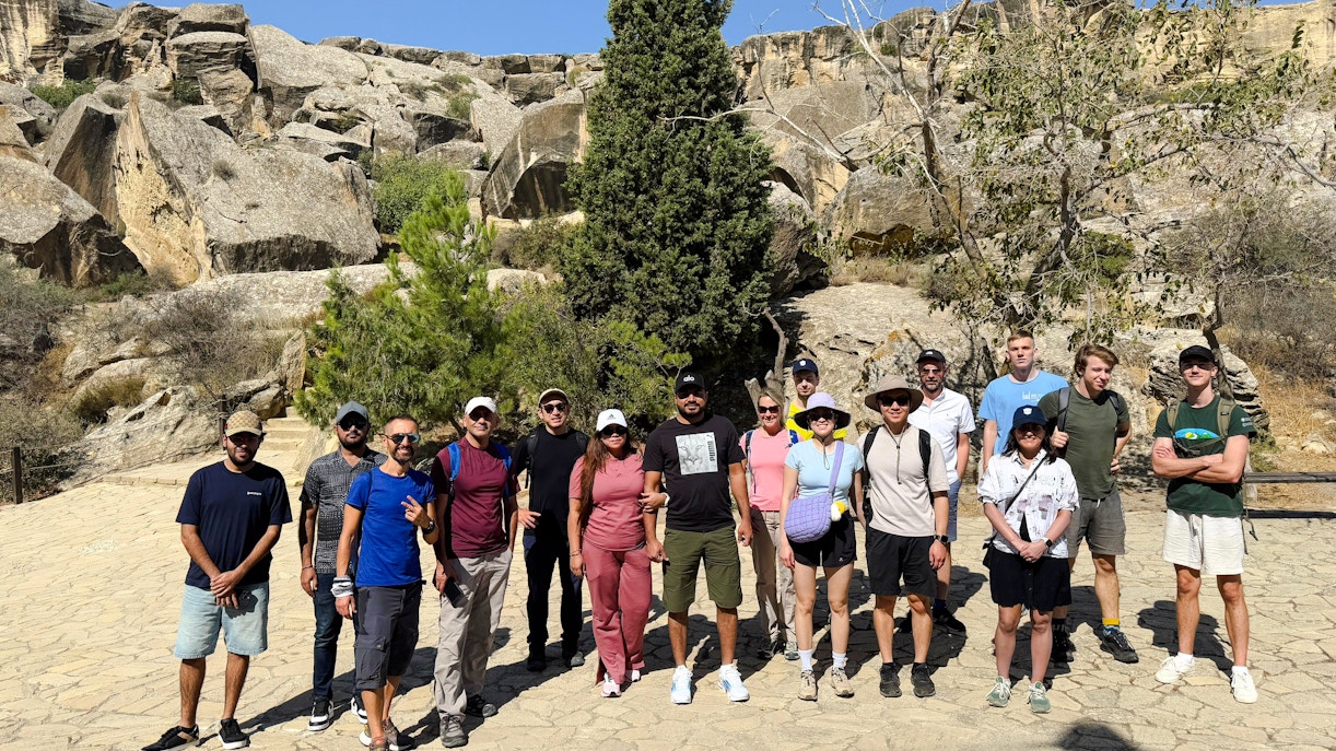 Group of tourists at Gobustan National Park with rocky landscape in Azerbaijan.