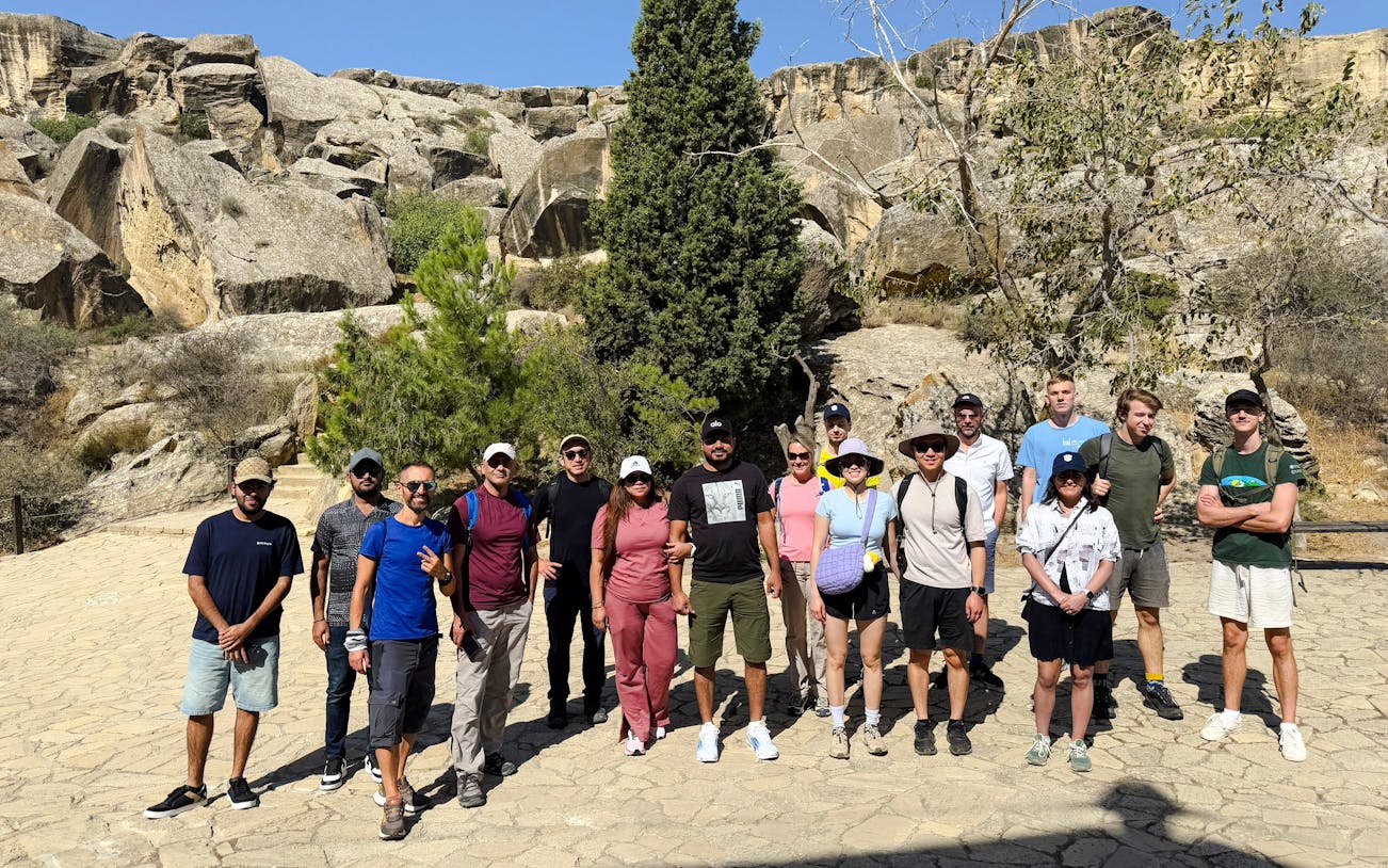Group of tourists at Gobustan National Park with rocky landscape in Azerbaijan.