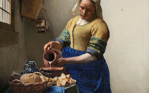 Woman pouring milk in Vermeer's "The Milkmaid" at Rijksmuseum, Amsterdam.