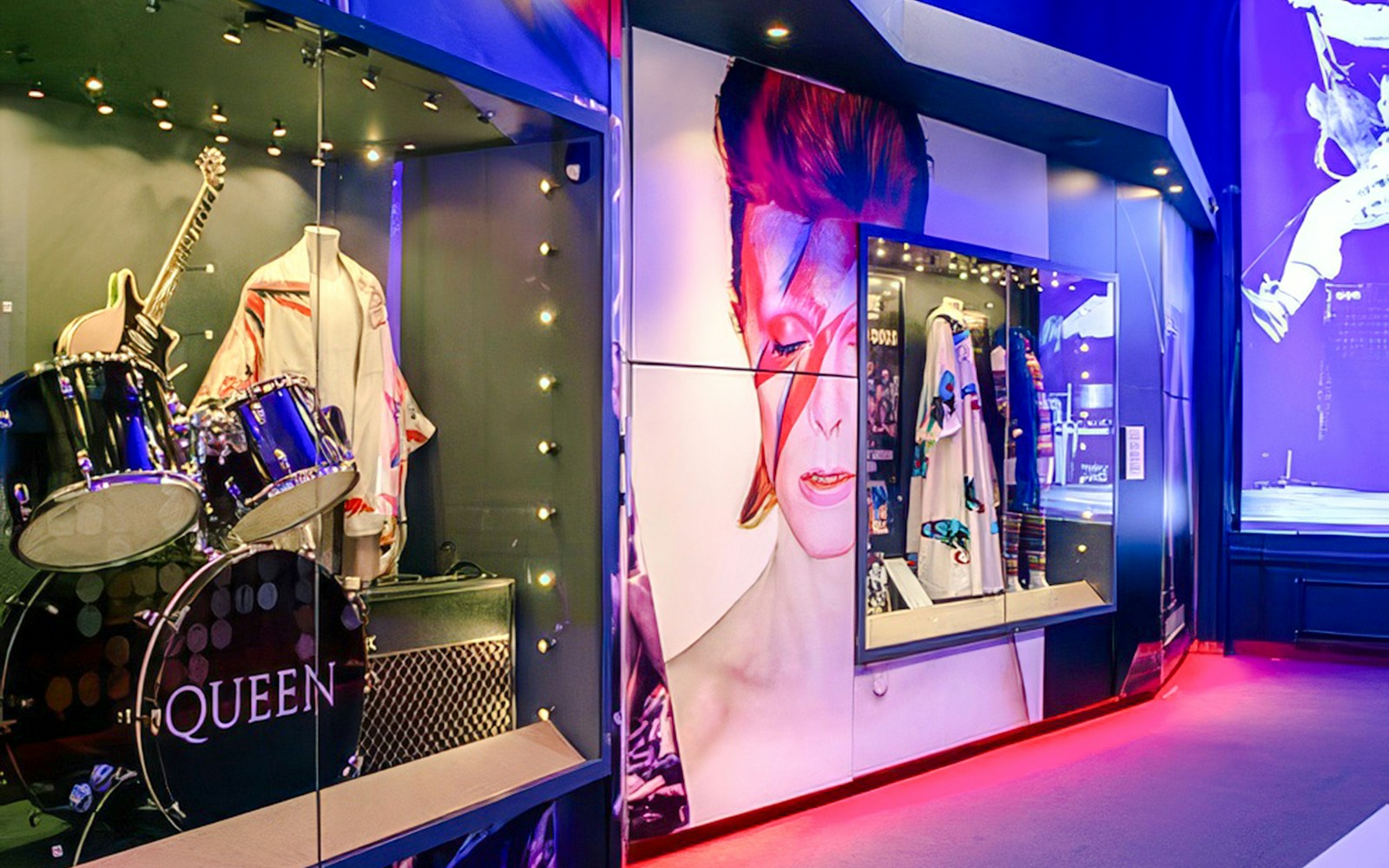 Drum set and guitar display with iconic music memorabilia inside the British Music Experience, Liverpool.