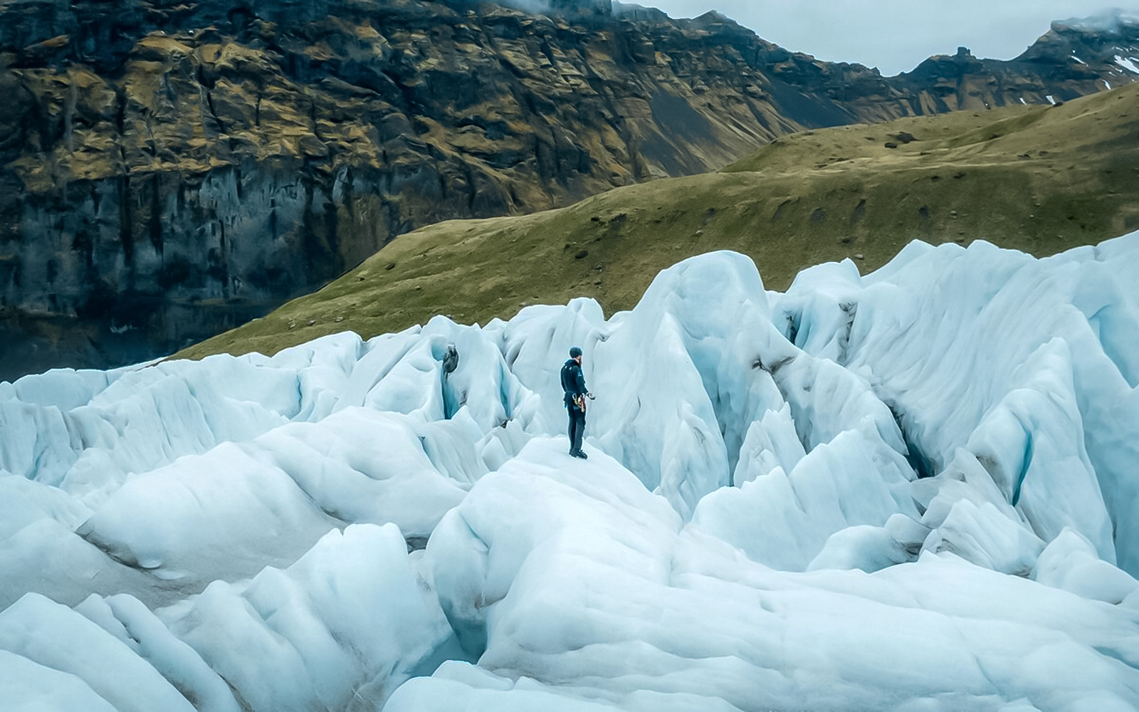 Explorer navigating ice maze and glacier crevasses in Skaftafell, Iceland.