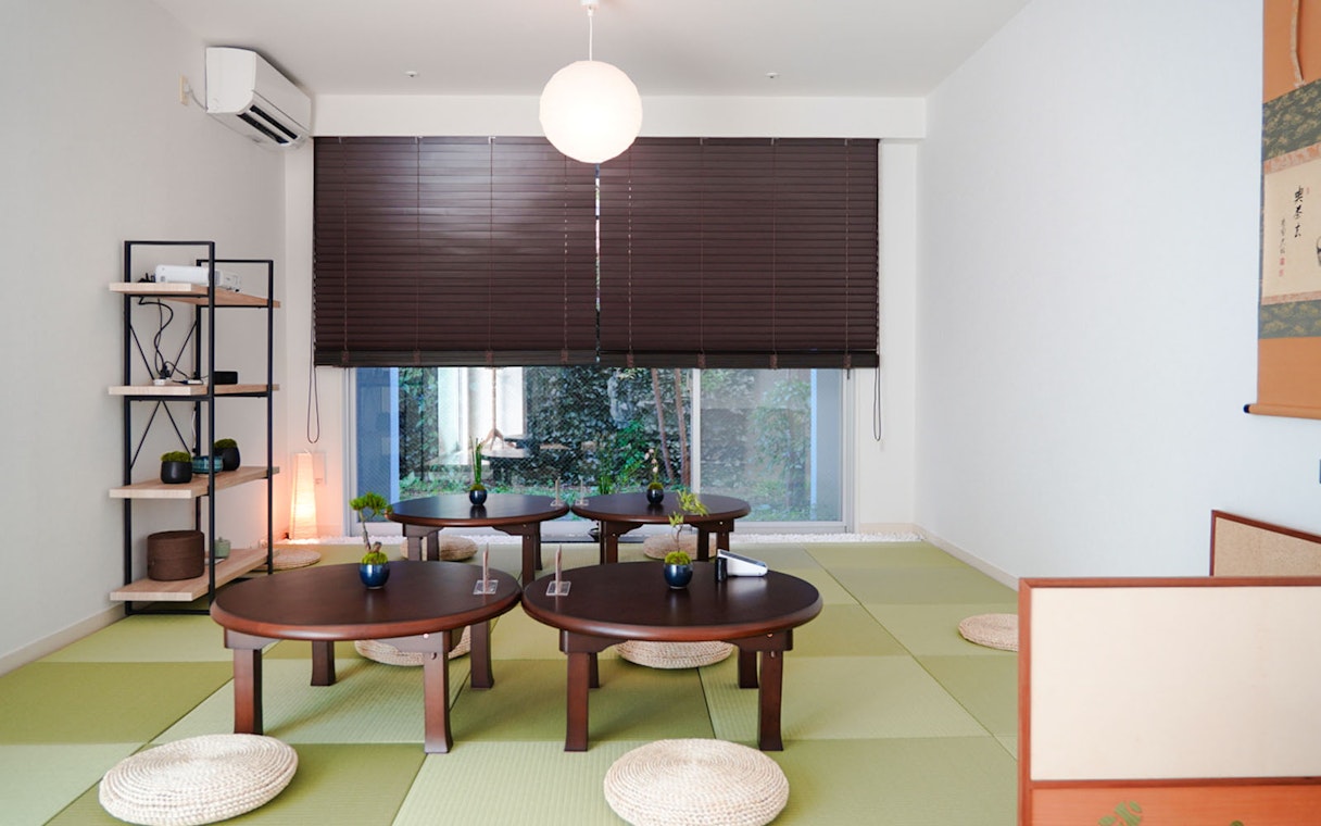 Tatami room setup for Tokyo Matcha & Kimono Experience with low tables and cushions.