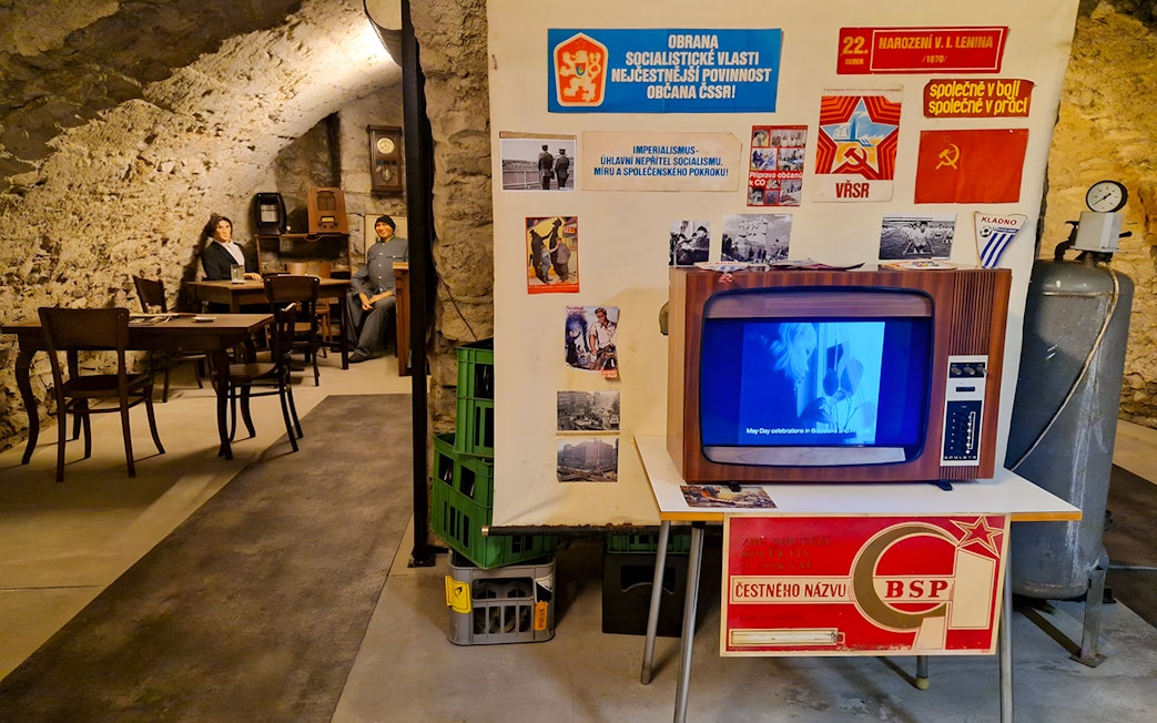 Prague Beer Museum interior with vintage TV and historical posters.