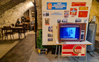 Prague Beer Museum interior with vintage TV and historical posters.
