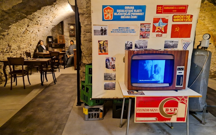 Prague Beer Museum interior with vintage TV and historical posters.