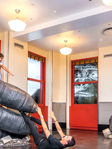 Children playing on giant gorilla hands at Empire State Building Observatory, New York City.