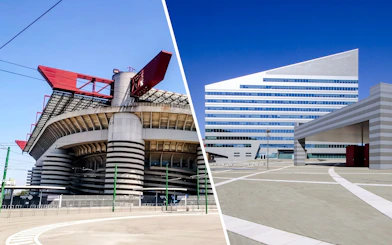 San Siro Stadium with red roof structures in Milan, Italy, next to modern building.