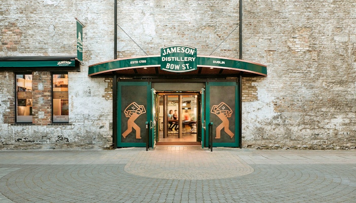 Jameson Whiskey Distillery exterior in Dublin with visitors entering for a guided tour.