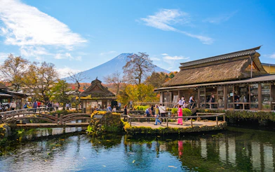 Visitors at Oshino Hakkai ponds with Mount Fuji in the background, Japan.