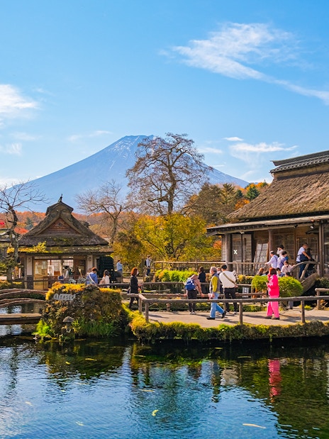 Visitors at Oshino Hakkai ponds with Mount Fuji in the background, Japan.
