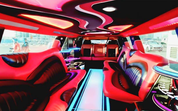 Interior of a luxury limousine in Dubai with vibrant seating and ambient lighting.