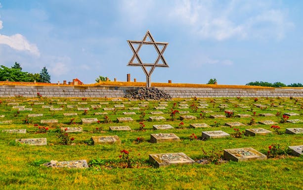 Terezin concentration camp cemetery with Star of David memorial.