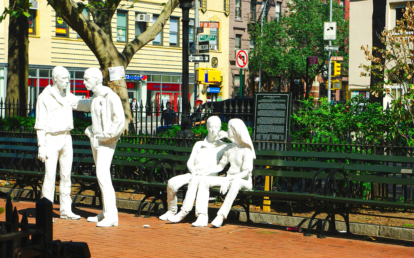 Sculptures of people interacting in Christopher Park, NYC.