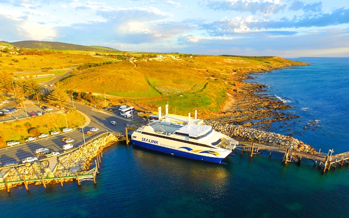 Sea link ferry docked at Kangaroo Island with coastal landscape in the background.