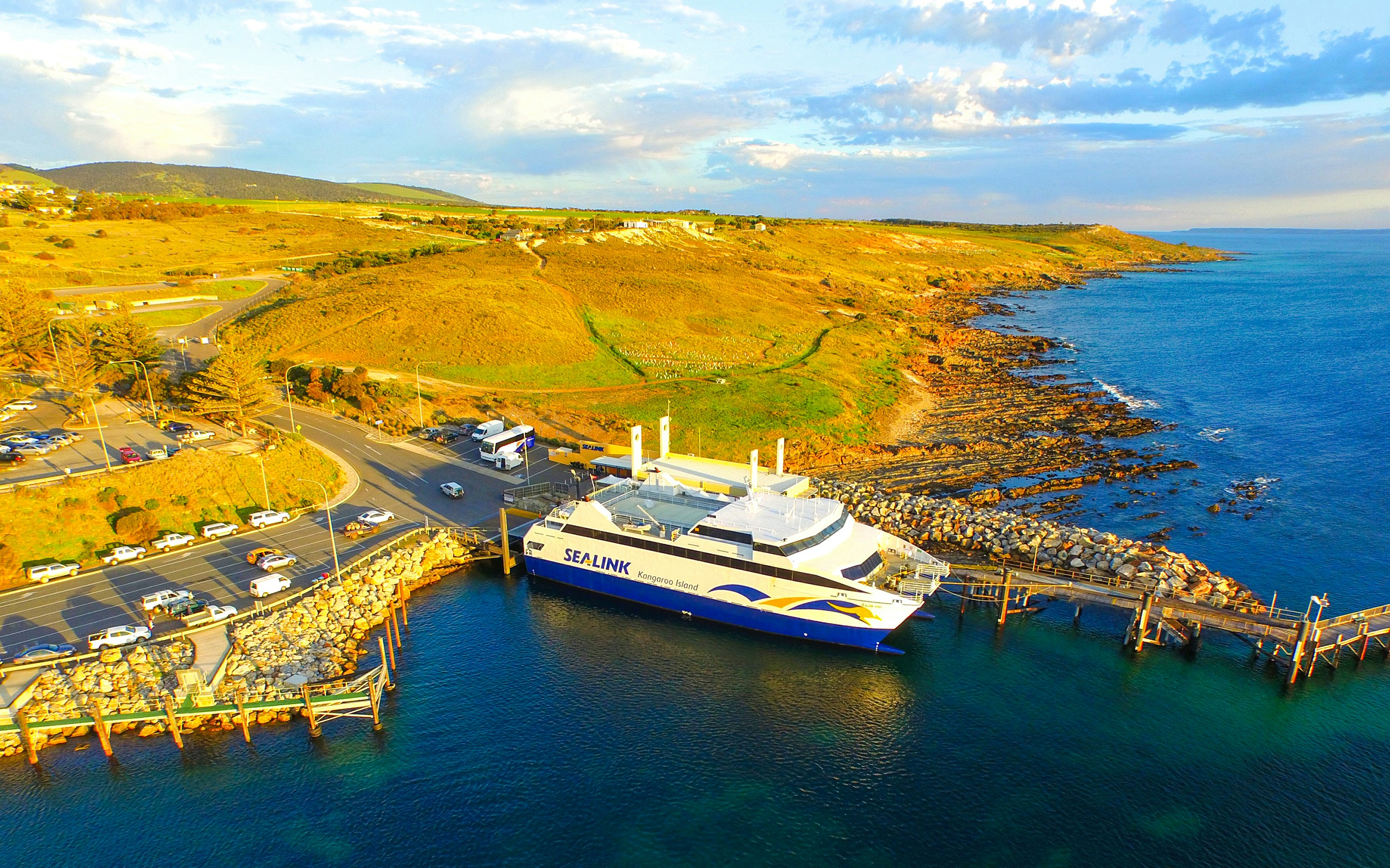 Sea link ferry docked at Kangaroo Island with coastal landscape in the background.