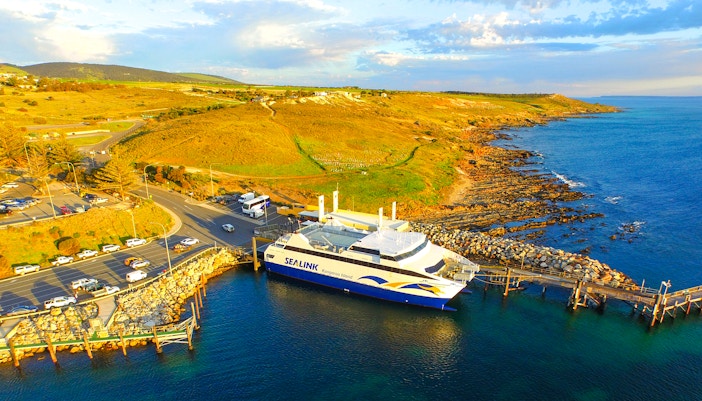 Sea link ferry docked at Kangaroo Island with coastal landscape in the background.
