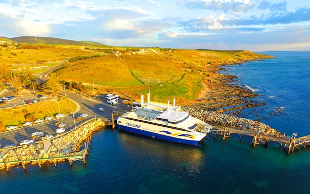 Sea link ferry docked at Kangaroo Island with coastal landscape in the background.