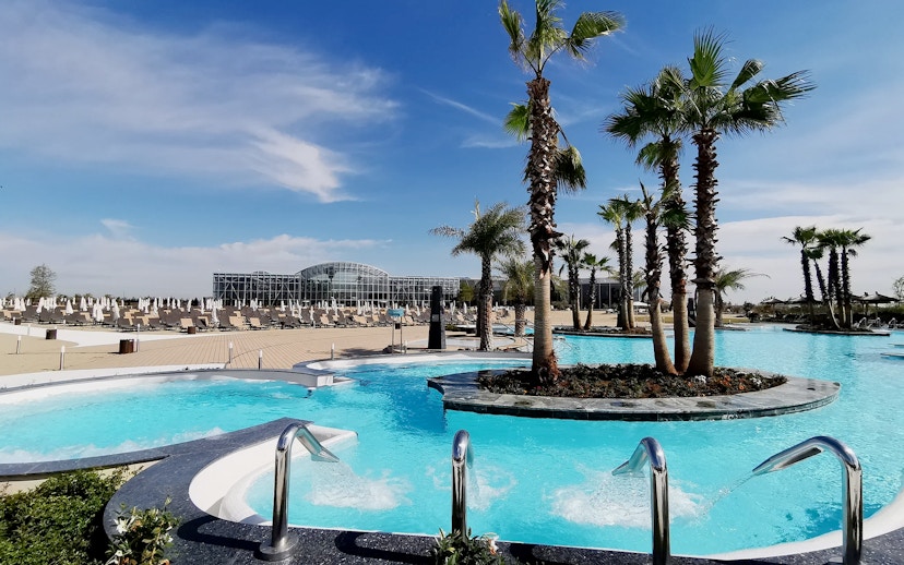 Therme Bucuresti Spa pools with palm trees in Bucharest, Romania.