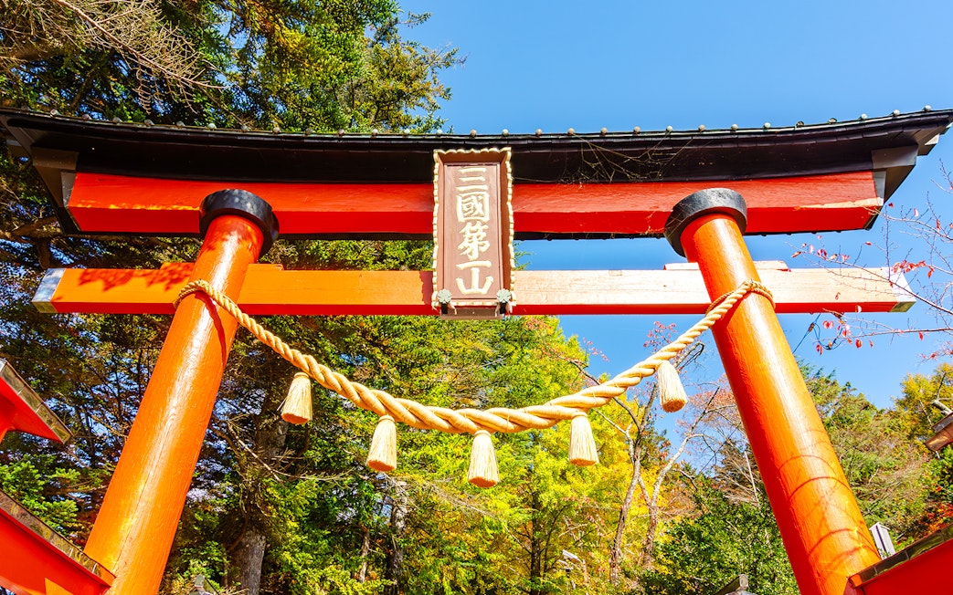 Torii gate with rope detail in autumn, leading to Chureito Pagoda, Arakura, Japan.