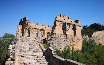 Mutianyu Great Wall section with stone steps and ancient watchtower in Beijing, China.