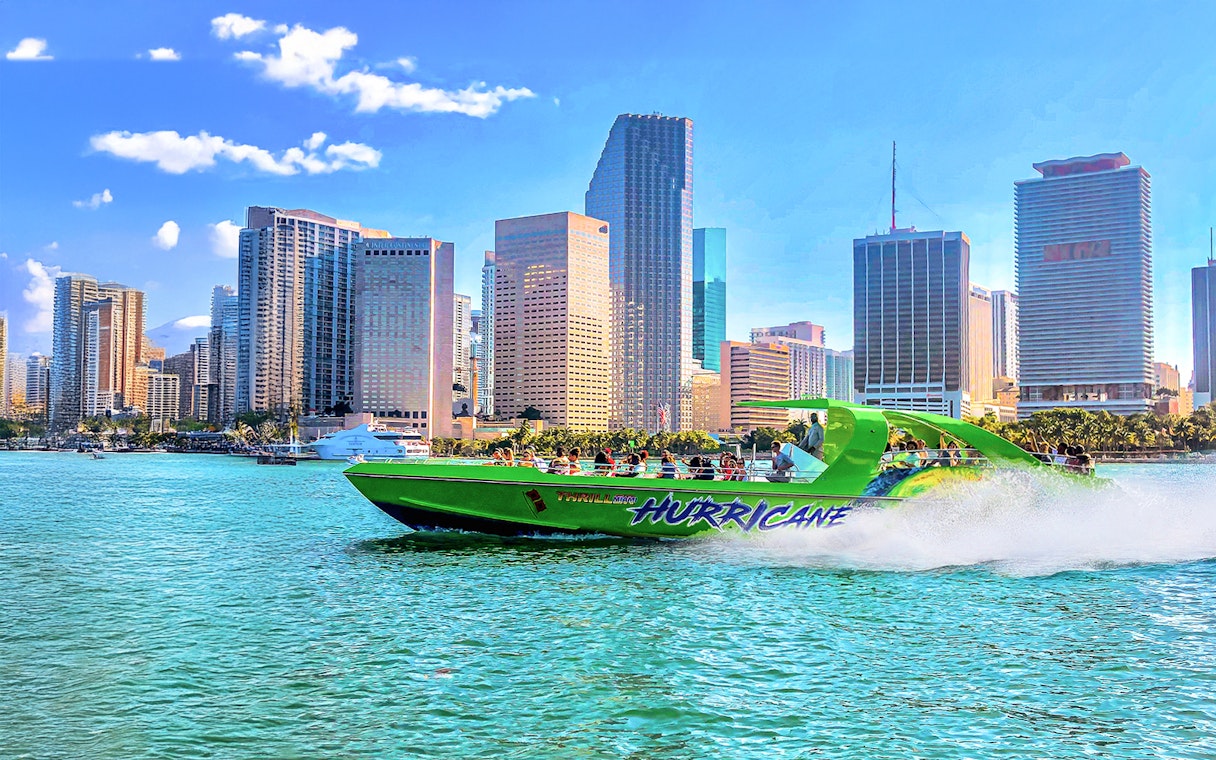Speedboat on Miami waters with city skyline in the background.