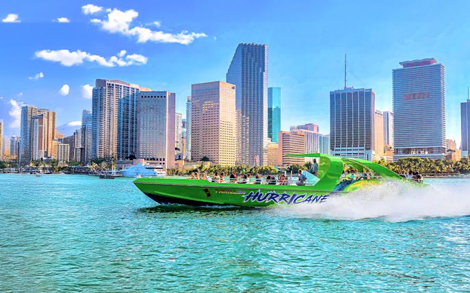 Speedboat on Miami waters with city skyline in the background.